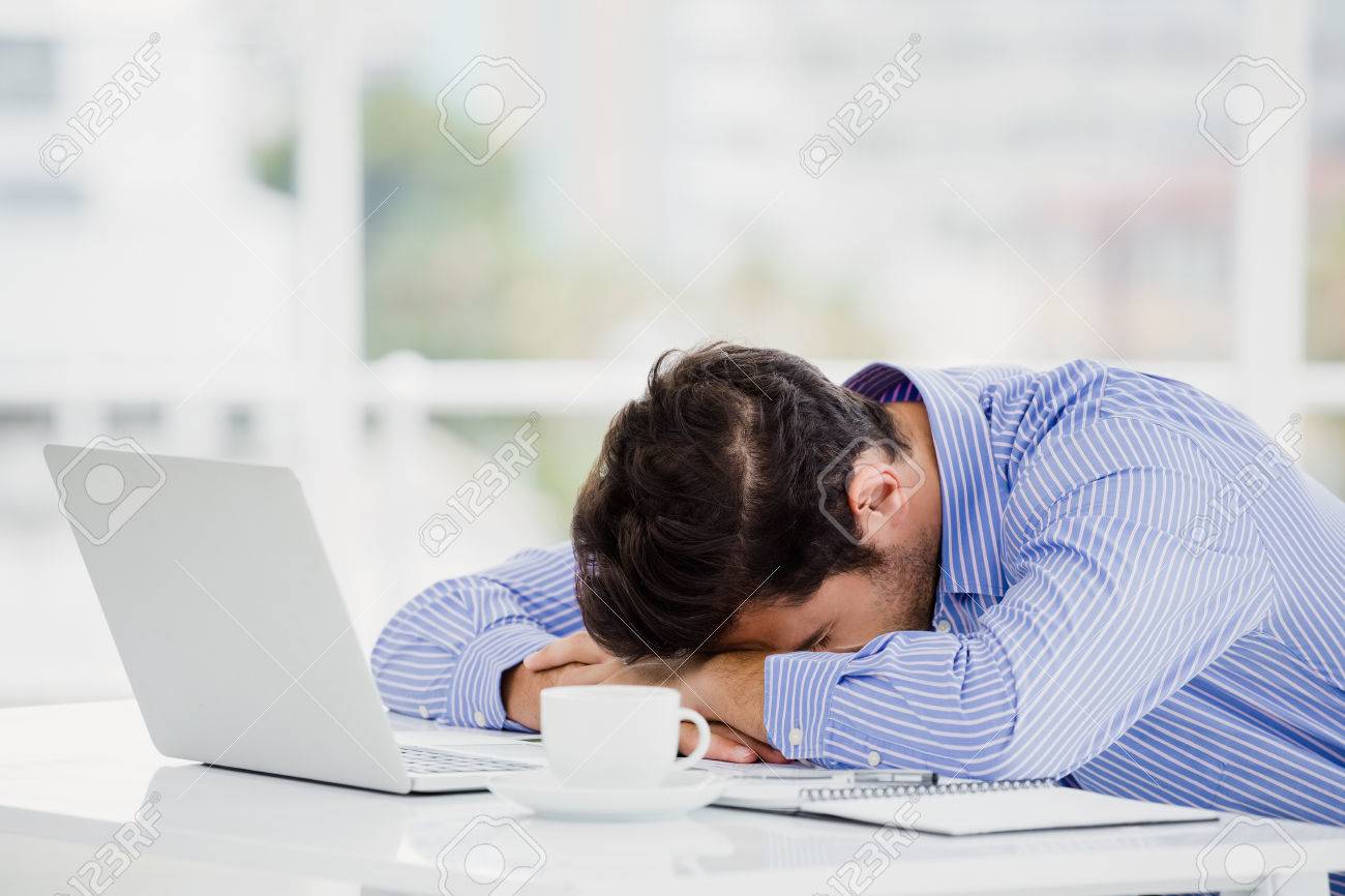 54926985-businessman-putting-his-head-down-on-desk-in-office.jpg