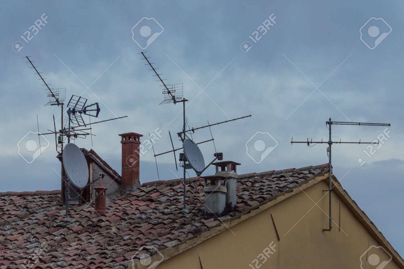 93054455-lot-of-different-types-of-antennas-on-the-roof-of-a-building.jpg