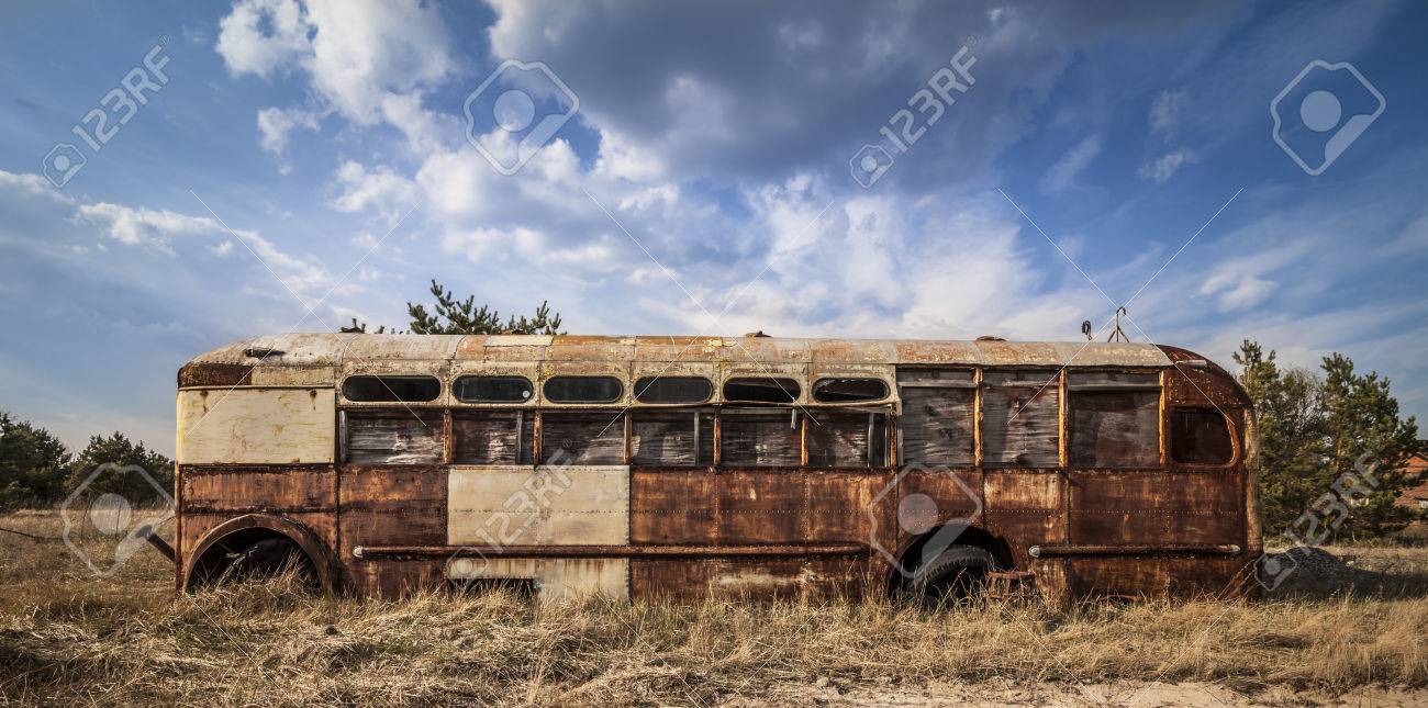 43203334-Abandoned-and-rusty-bus-in-a-field-in-a-sunny-day-with-blue-sky-and-clouds-in-the-Chernobyl-nuclear--Stock-Photo.jpg